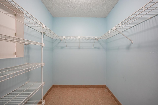 spacious closet featuring tile patterned floors