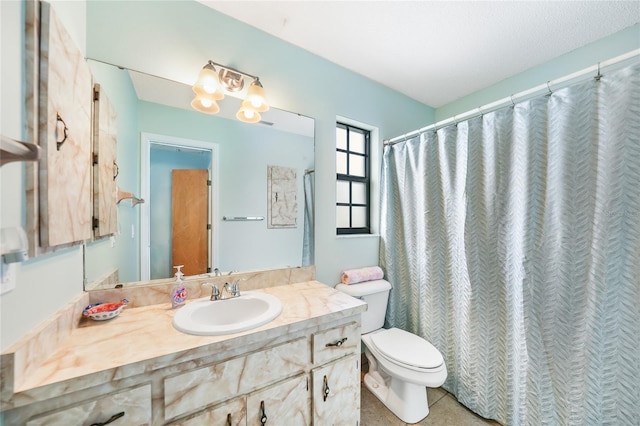 bathroom featuring tile patterned flooring, vanity, and toilet