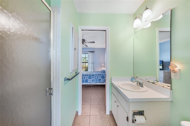 bathroom with tile patterned flooring, vanity, ceiling fan, and an enclosed shower