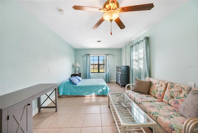 tiled bedroom featuring ceiling fan