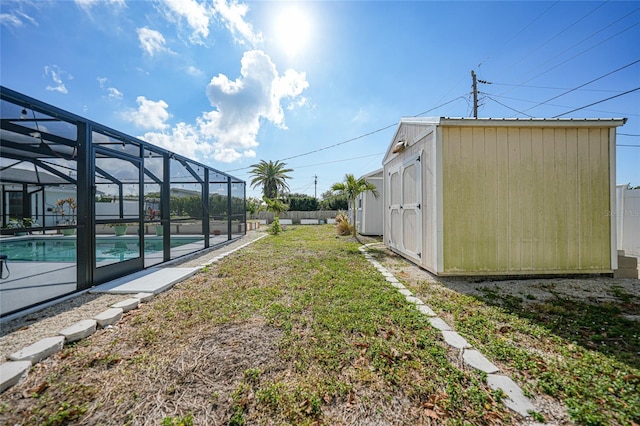 view of yard with glass enclosure and a storage shed