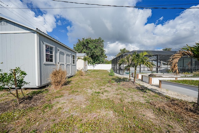 view of yard with a pool and glass enclosure