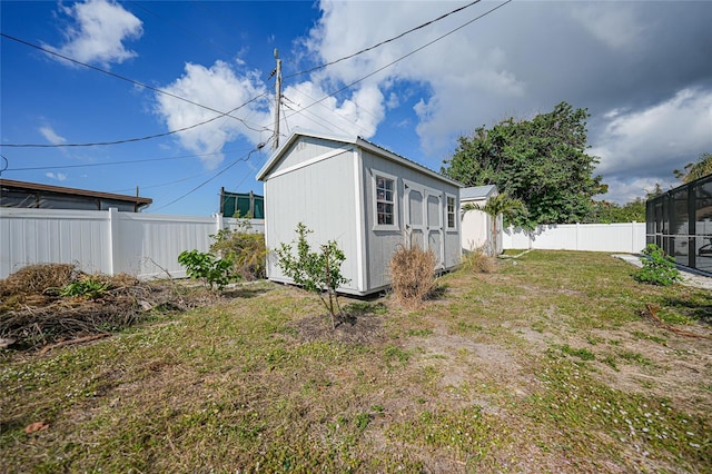 exterior space featuring a shed and a lanai