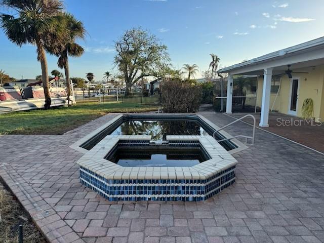 view of pool with an in ground hot tub and a patio area