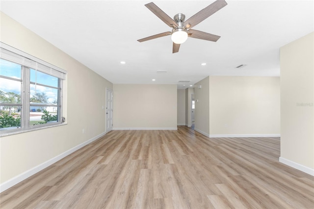 empty room with ceiling fan and light hardwood / wood-style floors