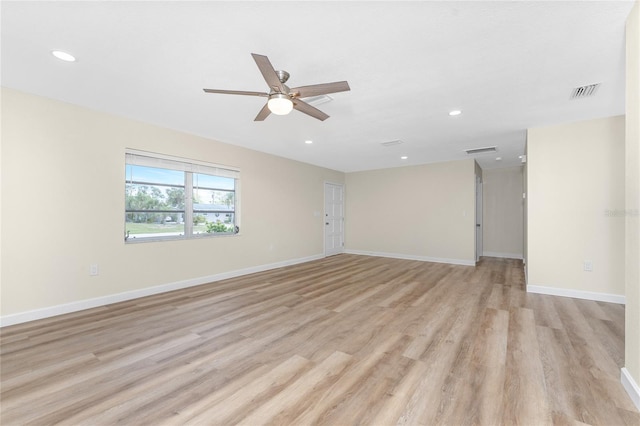 empty room with ceiling fan and light wood-type flooring