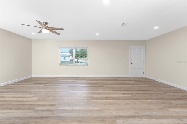 spare room featuring light hardwood / wood-style flooring and ceiling fan