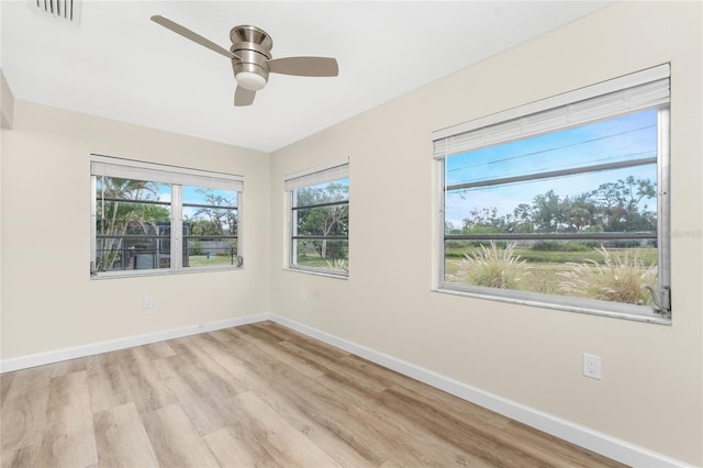 spare room featuring ceiling fan and light hardwood / wood-style flooring