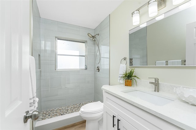 bathroom featuring vanity, toilet, wood-type flooring, and walk in shower