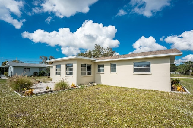 back of house featuring a yard