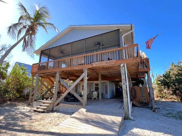 9526 Jolly Roger Trl, Placida, FL 33946 - rear view of property featuring ceiling fan, a wooden deck, and a sunroom