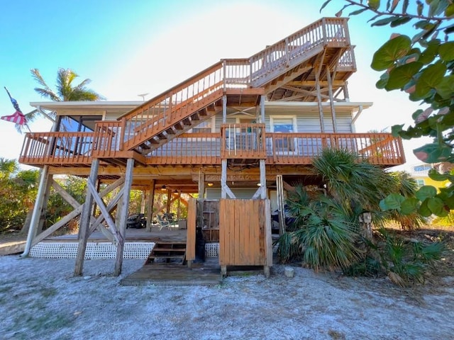 back of property featuring a deck and stairway