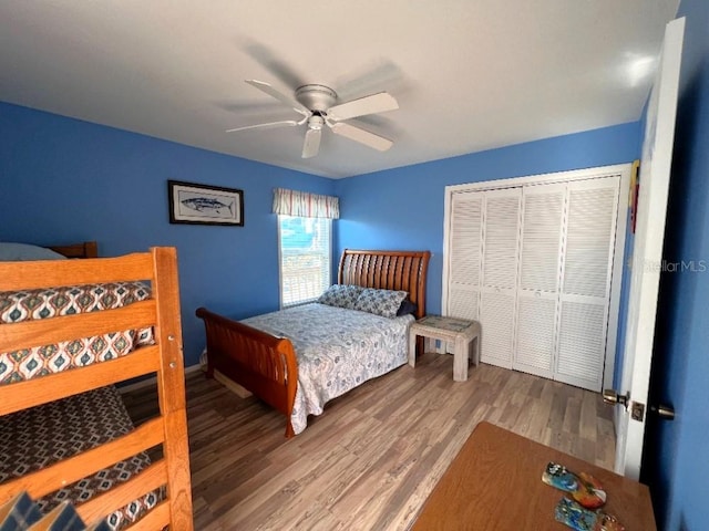 bedroom featuring a closet, wood finished floors, and a ceiling fan