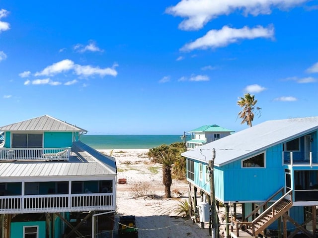 property view of water featuring a view of the beach and stairway