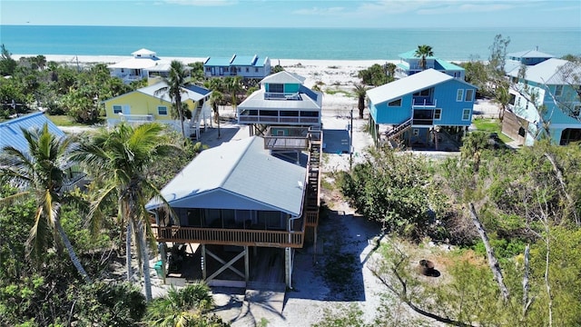 birds eye view of property featuring a beach view and a water view