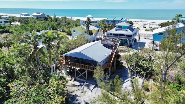 drone / aerial view featuring a view of the beach and a water view