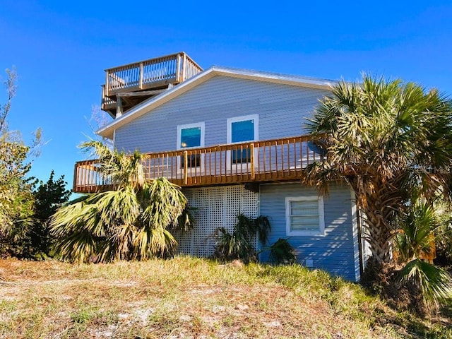 rear view of property featuring a deck