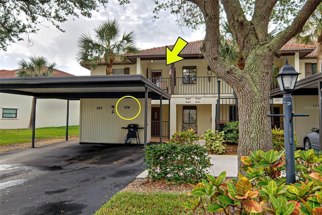 524 Pine Hollow Cir Unit 524, Englewood, FL 34223 - view of front facade featuring stucco siding, a tiled roof, and asphalt driveway