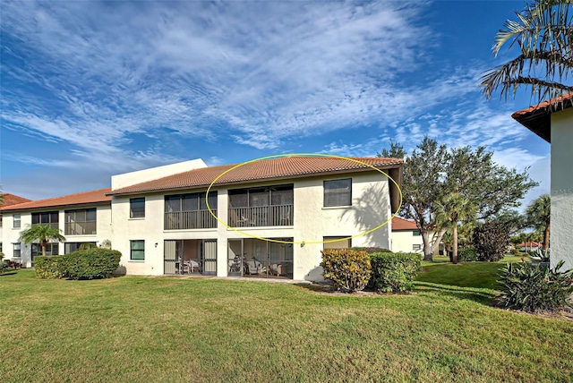524 Pine Hollow Cir Unit 524, Englewood, FL 34223 - rear view of house featuring stucco siding, a yard, a tiled roof, and a patio