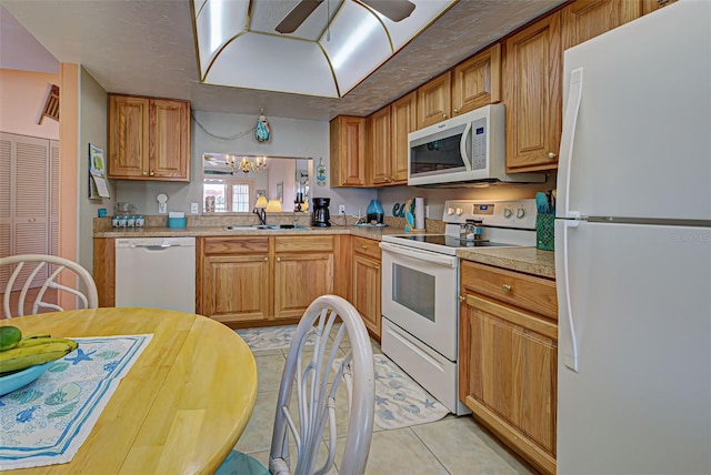 524 Pine Hollow Cir Unit 524, Englewood, FL 34223 - kitchen with white appliances, light tile patterned floors, light countertops, a chandelier, and ceiling fan