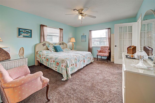 524 Pine Hollow Cir Unit 524, Englewood, FL 34223 - bedroom with carpet floors, multiple windows, and ceiling fan