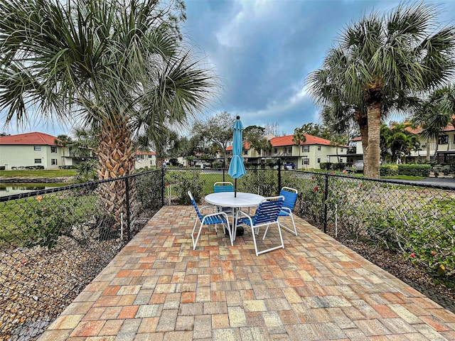 524 Pine Hollow Cir Unit 524, Englewood, FL 34223 - view of patio featuring outdoor dining space and a residential view