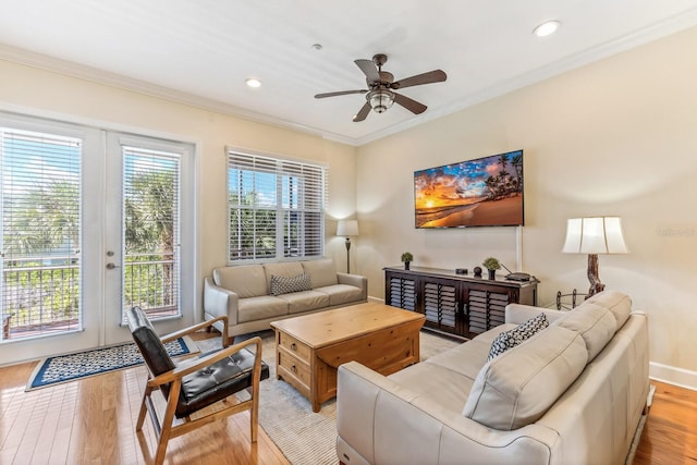 living room featuring french doors, light hardwood / wood-style flooring, ceiling fan, and ornamental molding