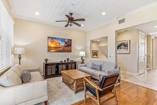 living room featuring crown molding, ceiling fan, and light hardwood / wood-style floors