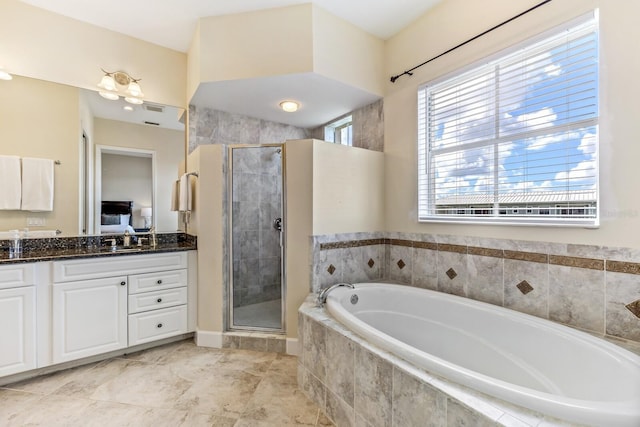 bathroom with vanity and separate shower and tub