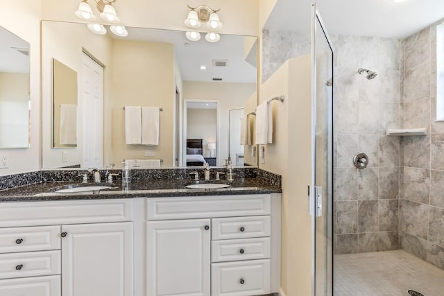 bathroom with vanity and a tile shower