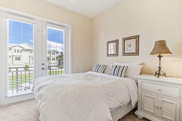 bedroom featuring light carpet and access to outside