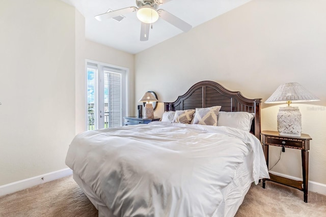 bedroom featuring ceiling fan, light colored carpet, and vaulted ceiling