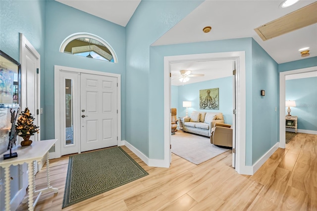 entrance foyer featuring ceiling fan, hardwood / wood-style floors, and a high ceiling