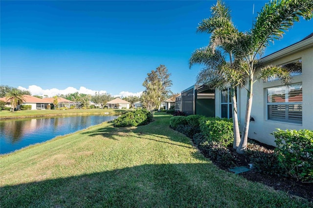 view of yard featuring a water view and a lanai