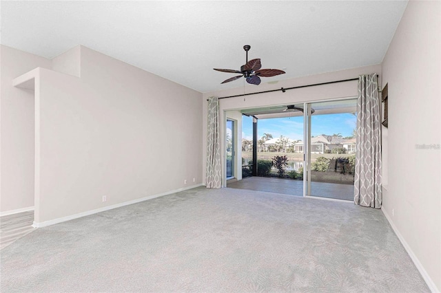 carpeted spare room with ceiling fan