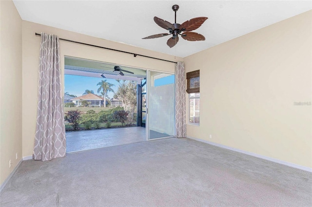 spare room with ceiling fan and light colored carpet