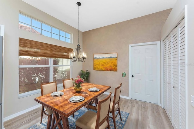 dining room featuring light hardwood / wood-style floors and a chandelier