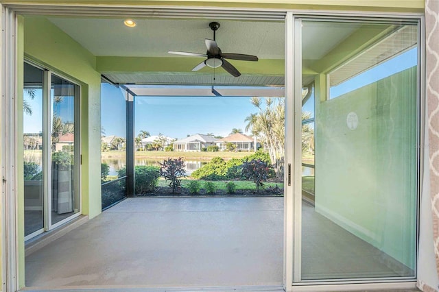 exterior space with a water view and ceiling fan