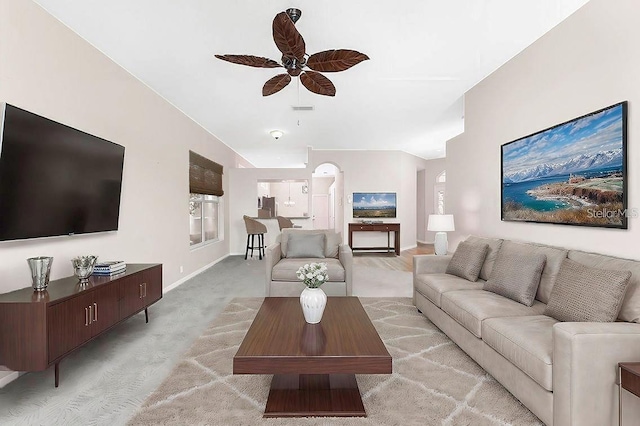 carpeted living room with ceiling fan