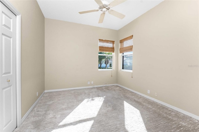 carpeted spare room with ceiling fan