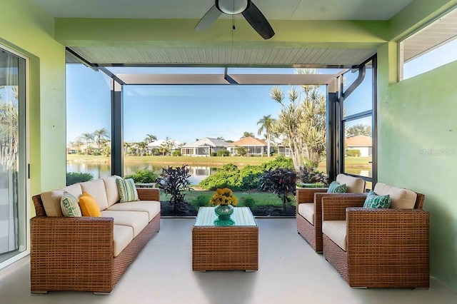 sunroom / solarium featuring ceiling fan, a water view, and a healthy amount of sunlight