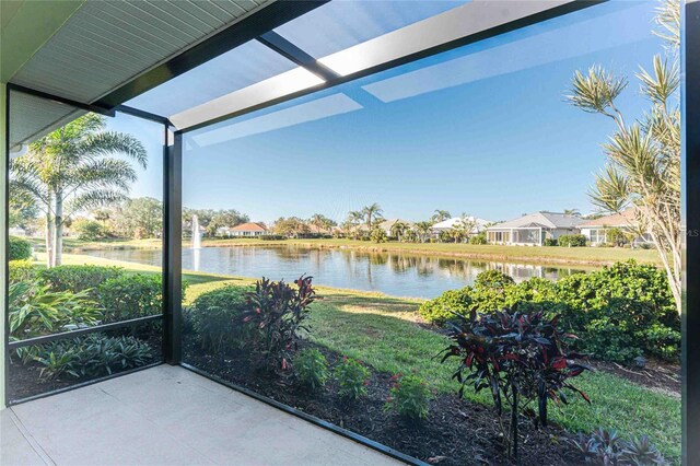 unfurnished sunroom featuring a water view