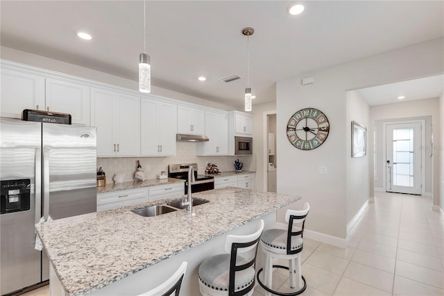 kitchen featuring white cabinets, pendant lighting, sink, and appliances with stainless steel finishes