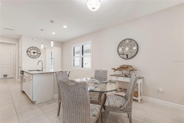 dining space featuring light tile patterned flooring and sink