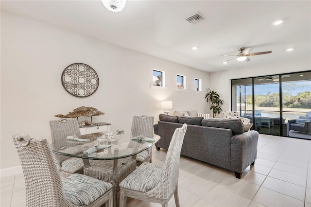 tiled dining area with ceiling fan