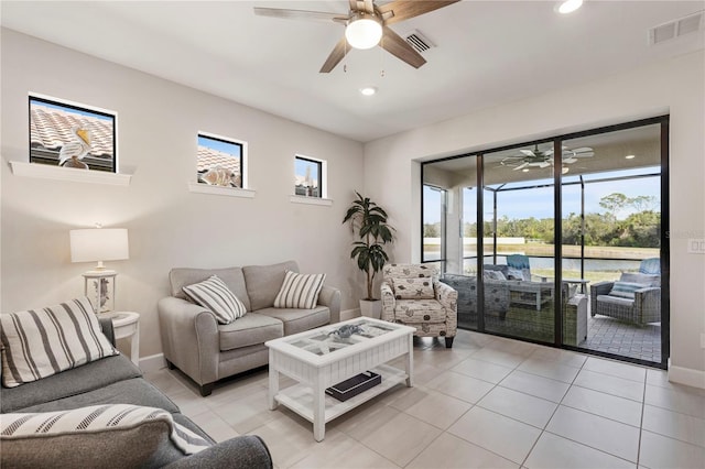 living room featuring ceiling fan and light tile patterned floors