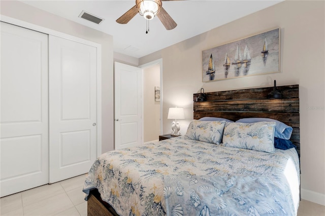 bedroom featuring light tile patterned floors, a closet, and ceiling fan