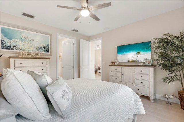 bedroom with ceiling fan and light tile patterned floors