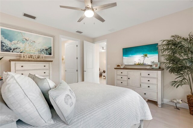 bedroom featuring light tile patterned floors and ceiling fan