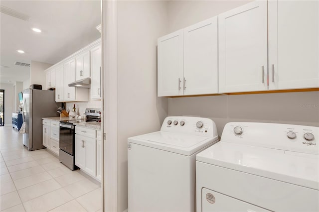 washroom with light tile patterned floors and washing machine and clothes dryer